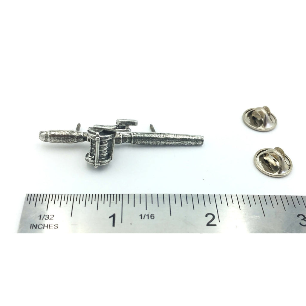 A handcrafted Bait Casting Rod Reel Pin next to a ruler, available for sale at Creativeartisan.com - the image offers a sense of scale