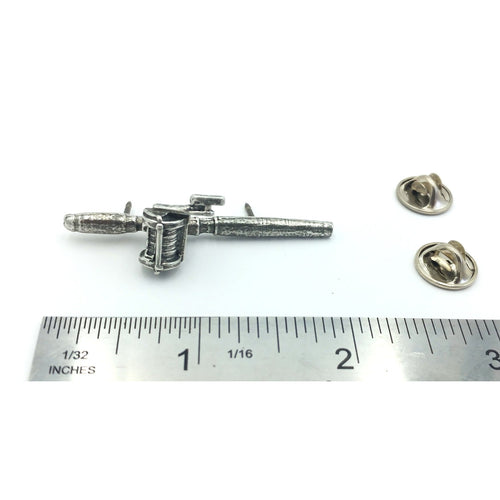 A handcrafted Bait Casting Rod Reel Pin next to a ruler, available for sale at Creativeartisan.com - the image offers a sense of scale