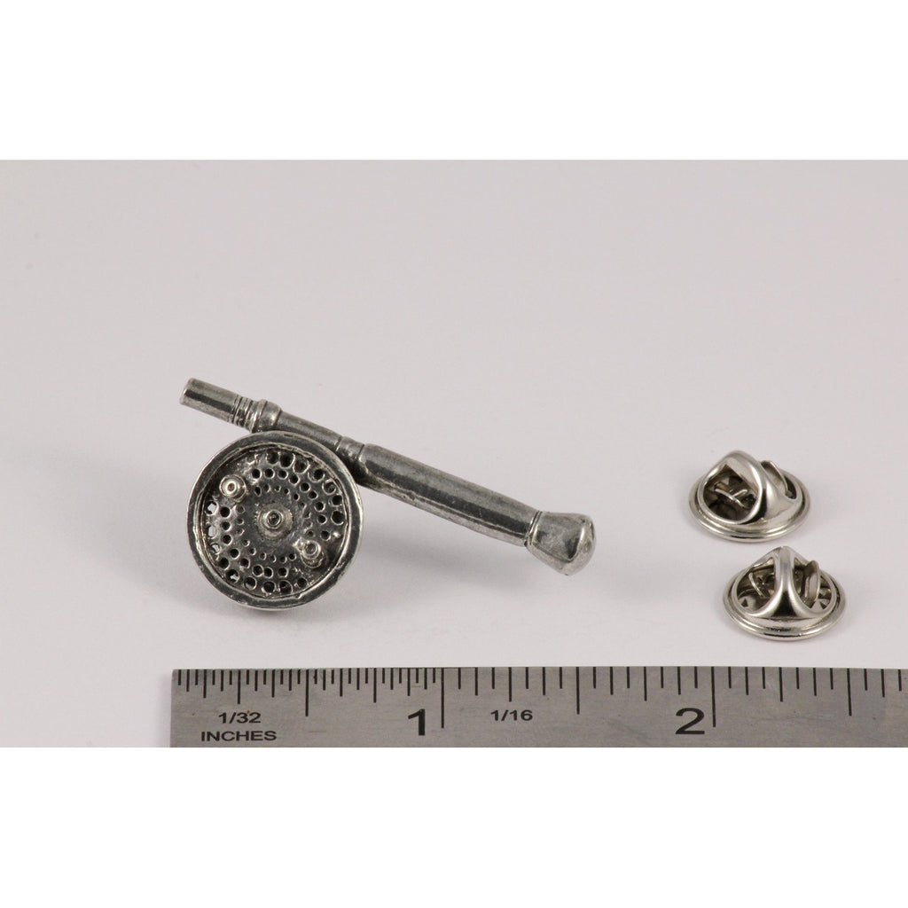A handcrafted Saltwater Fly Rod Reel Pin next to a ruler, available for sale at Creativeartisan.com - the image offers a sense of scale