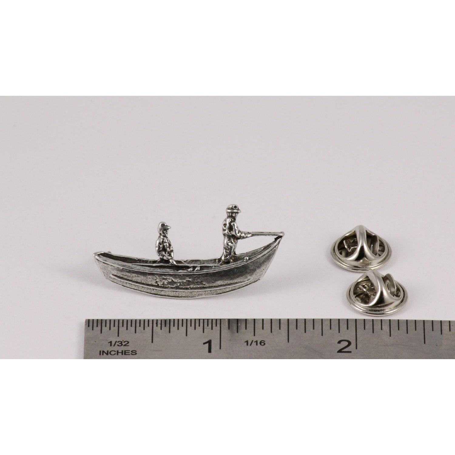 A handcrafted Drift Boat Pin next to a ruler, available for sale at Creativeartisan.com - the image offers a sense of scale