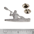A handcrafted Kayaker With Paddle Pin next to a ruler, available for sale at Creativeartisan.com - the image offers a sense of scale