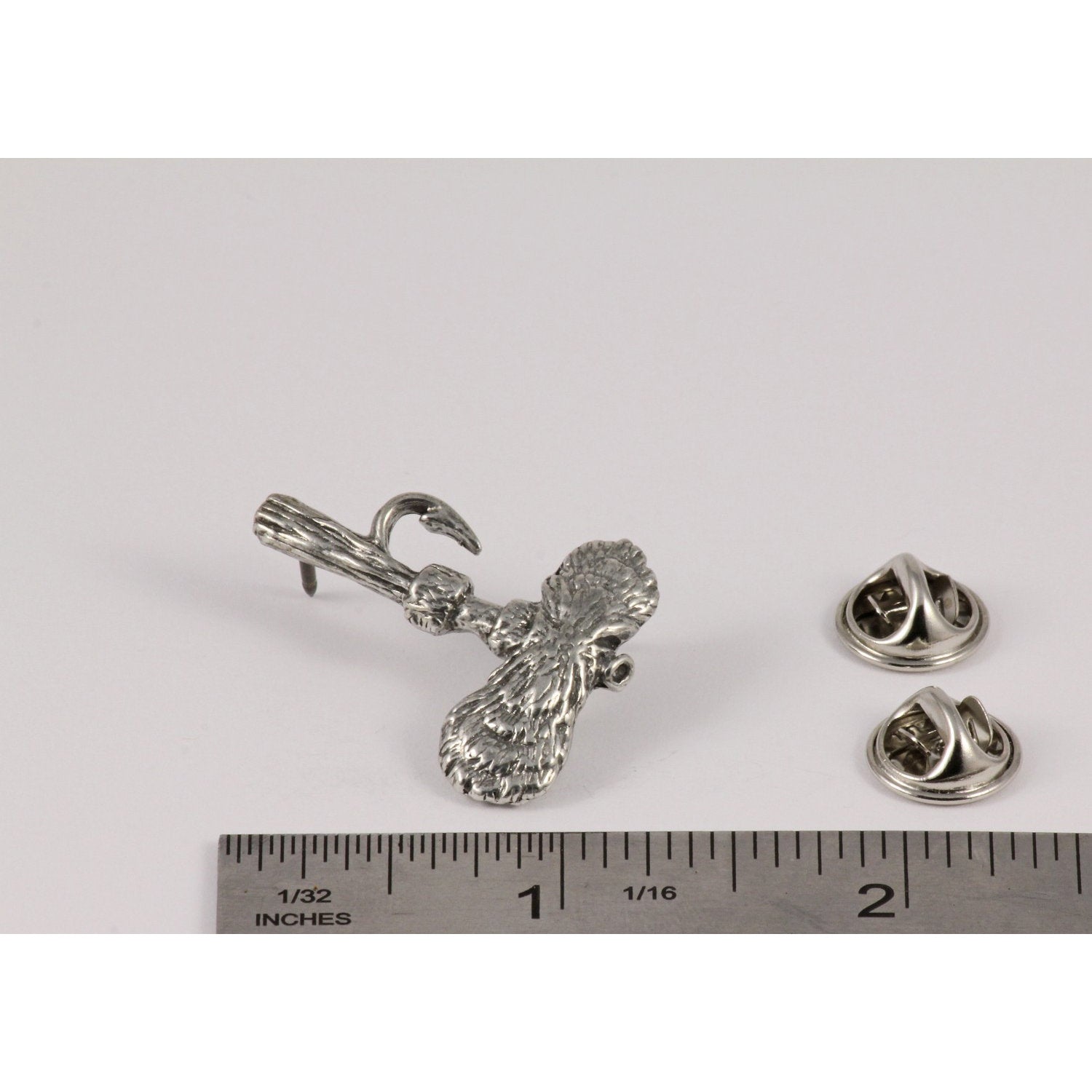 A handcrafted Royal Wulff Fly Pin next to a ruler, available for sale at Creativeartisan.com - the image offers a sense of scale