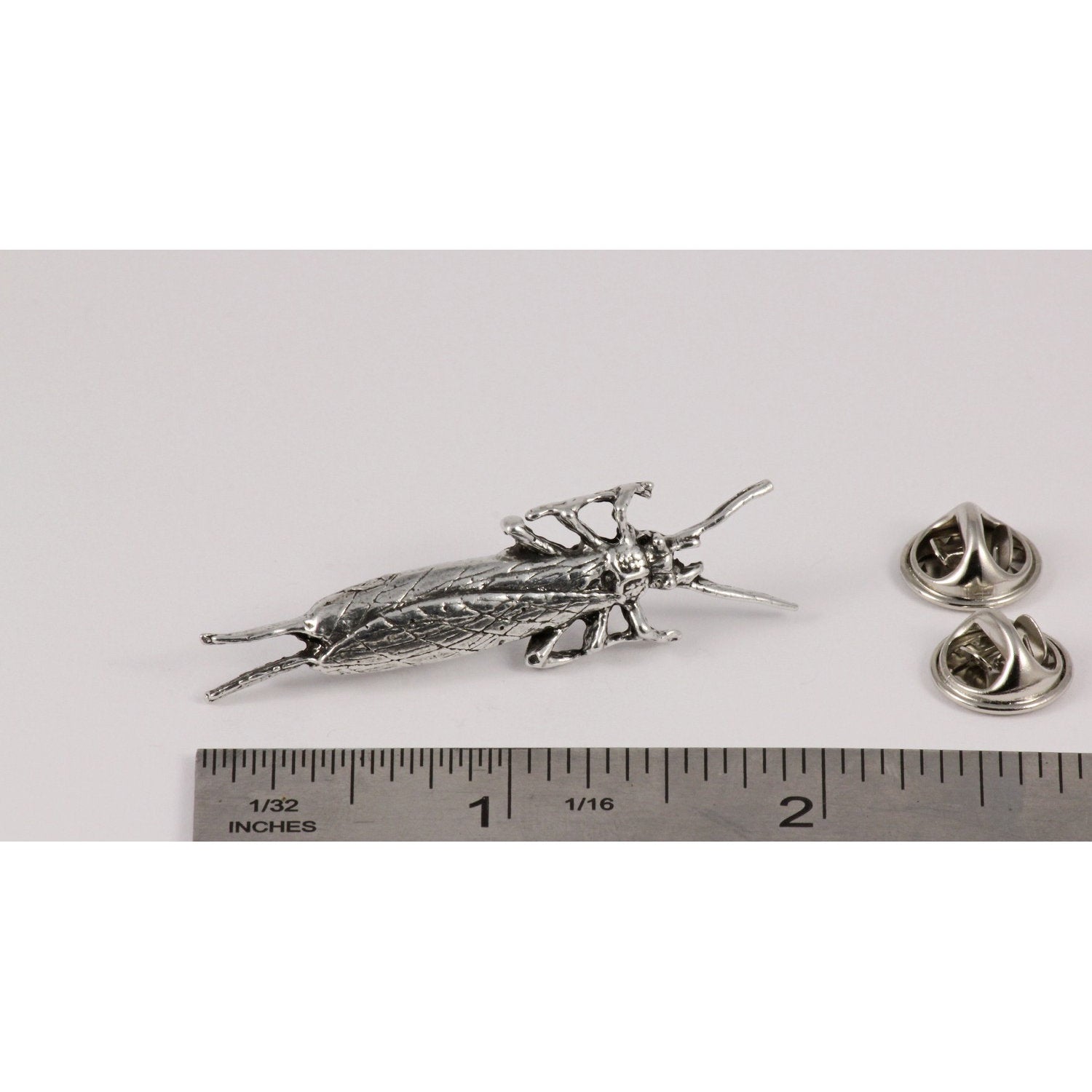 A handcrafted Salmon Fly Insect Pin next to a ruler, available for sale at Creativeartisan.com - the image offers a sense of scale