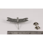 A handcrafted Dragon Fly Pin next to a ruler, available for sale at Creativeartisan.com - the image offers a sense of scale