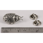 A handcrafted Ladybug Pin next to a ruler, available for sale at Creativeartisan.com - the image offers a sense of scale