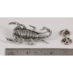 A handcrafted Scorpion Pin next to a ruler, available for sale at Creativeartisan.com - the image offers a sense of scale