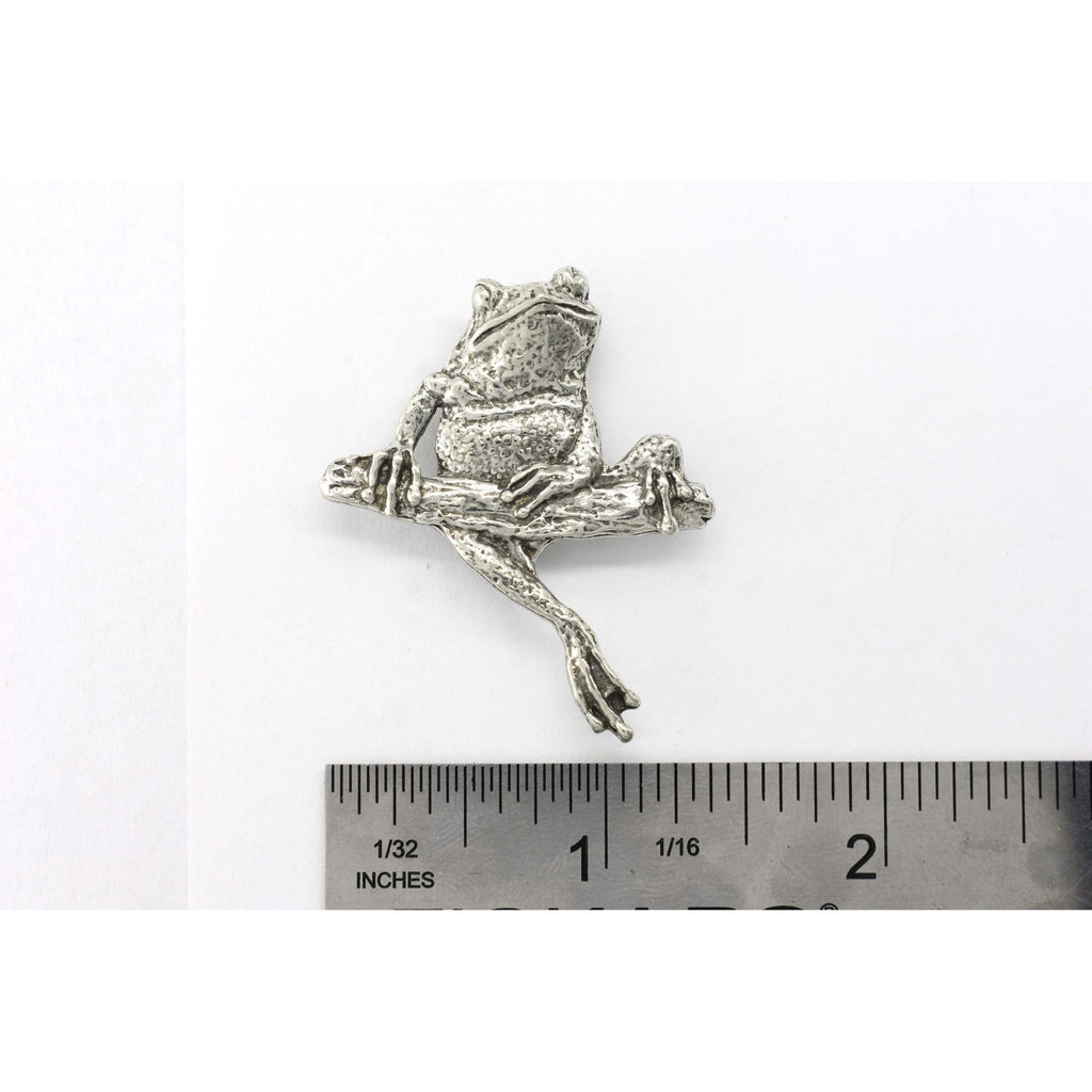 A handcrafted Frog On Branch Pin next to a ruler, available for sale at Creativeartisan.com - the image offers a sense of scale