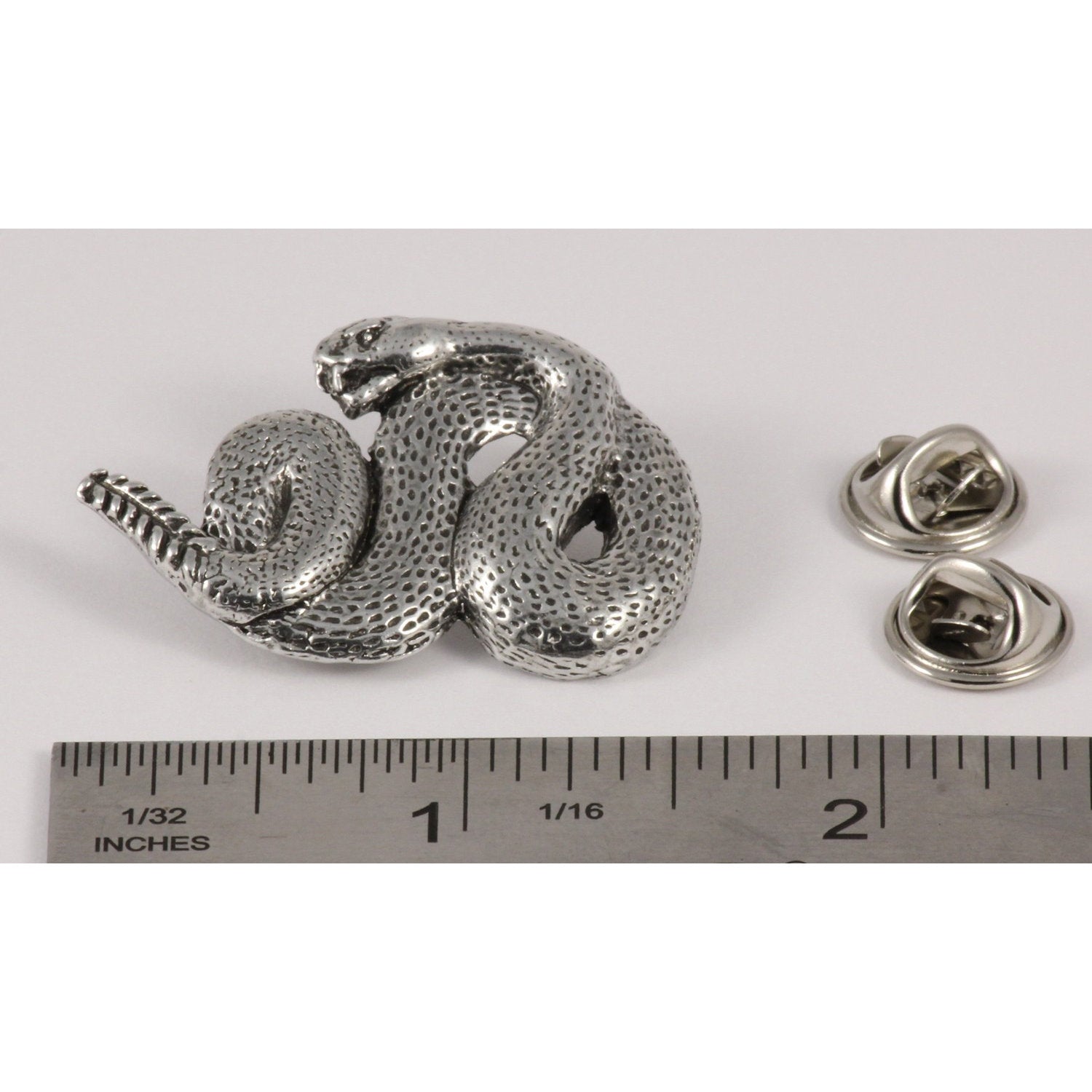 A handcrafted Rattlesnake Pin next to a ruler, available for sale at Creativeartisan.com - the image offers a sense of scale