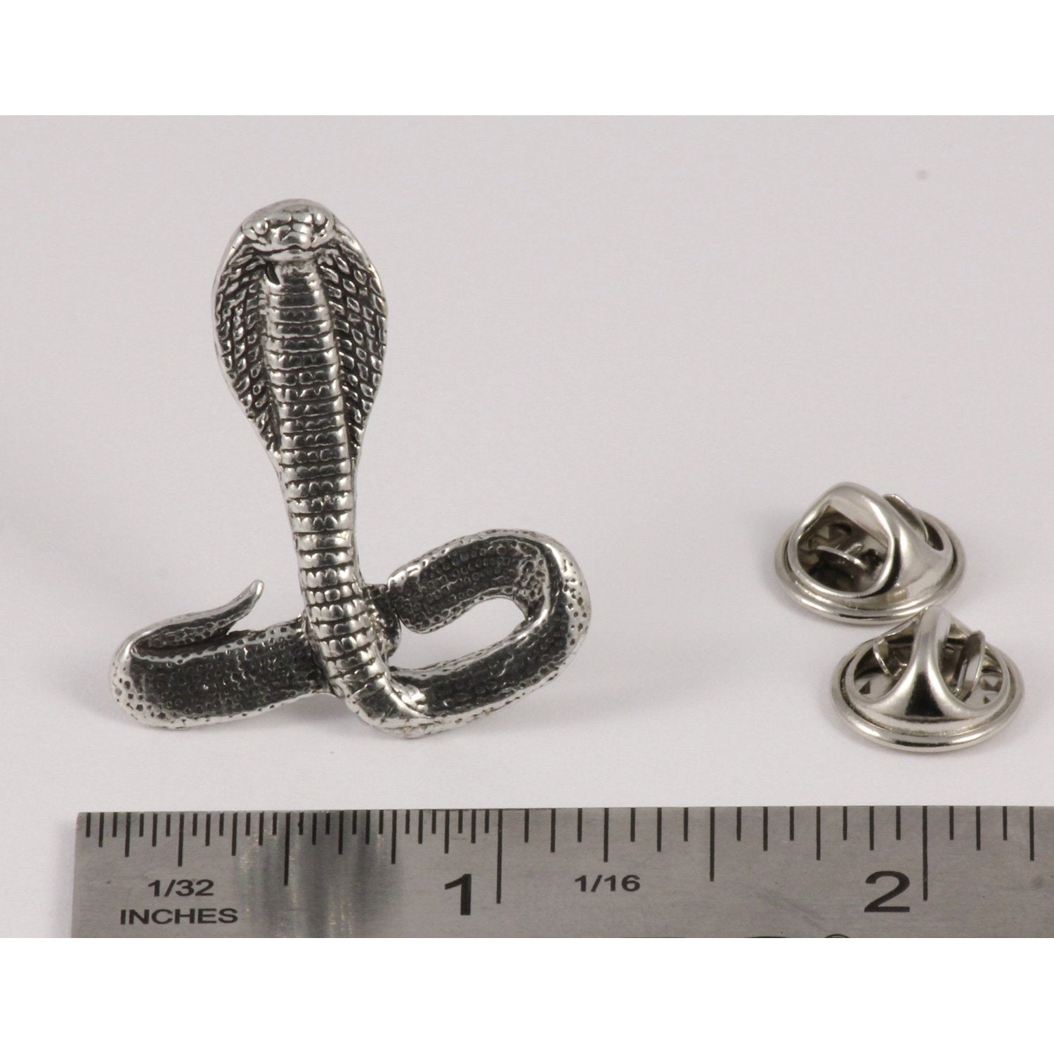 A handcrafted Cobra Pin next to a ruler, available for sale at Creativeartisan.com - the image offers a sense of scale