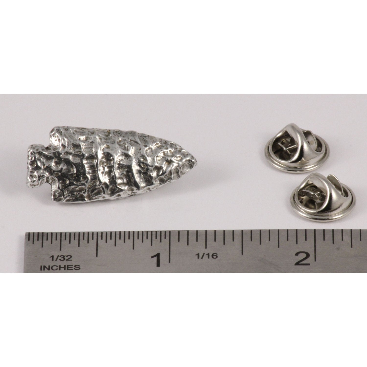 A handcrafted Native American Arrowhead Pin next to a ruler, available for sale at Creativeartisan.com - the image offers a sense of scale