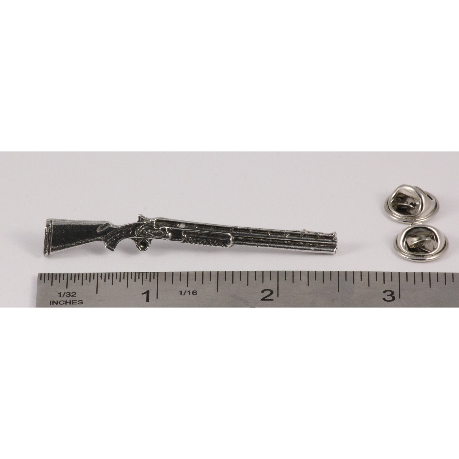 A handcrafted Over Under Shotgun Pin next to a ruler, available for sale at Creativeartisan.com - the image offers a sense of scale