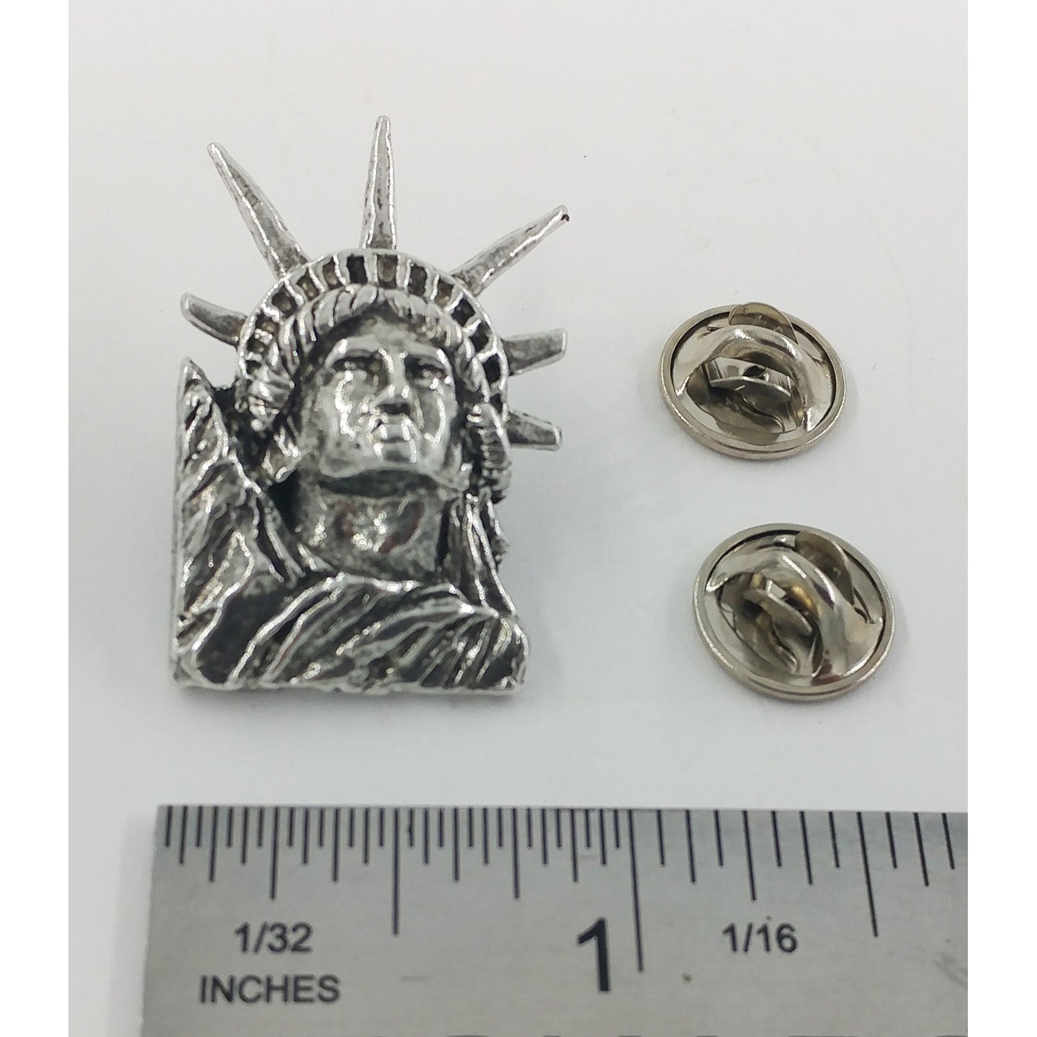 A handcrafted Lady Liberty Pin next to a ruler, available for sale at Creativeartisan.com - the image offers a sense of scale