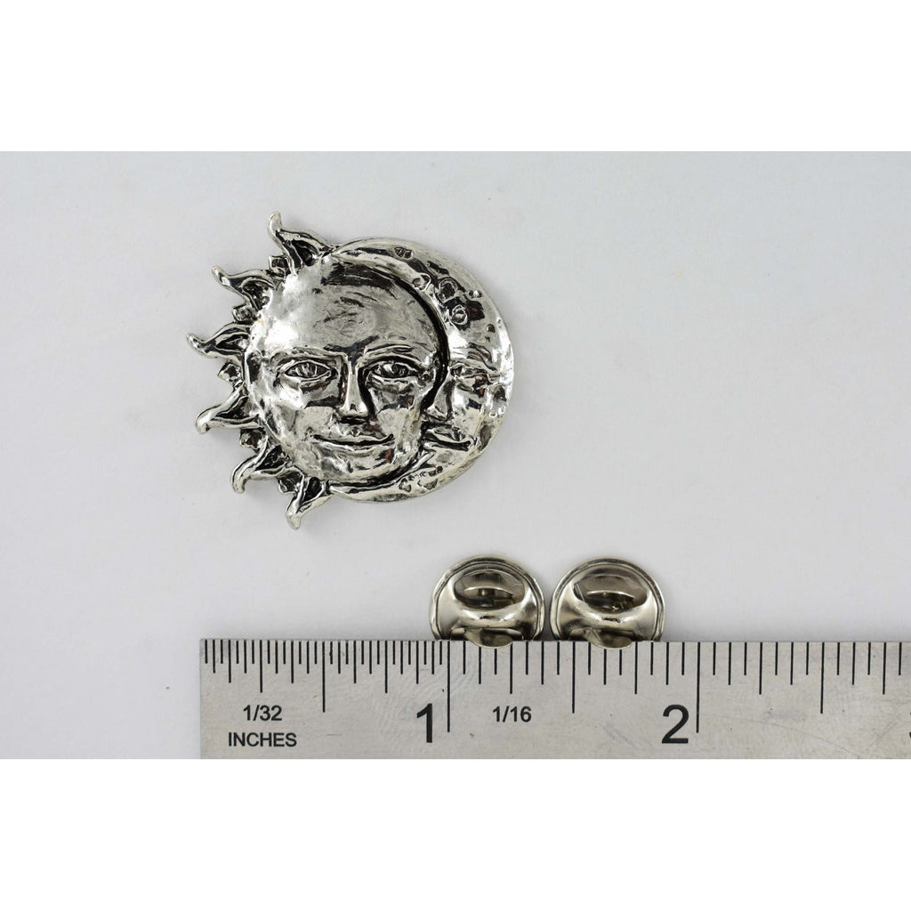 A handcrafted Sun And Moon Pin next to a ruler, available for sale at Creativeartisan.com - the image offers a sense of scale