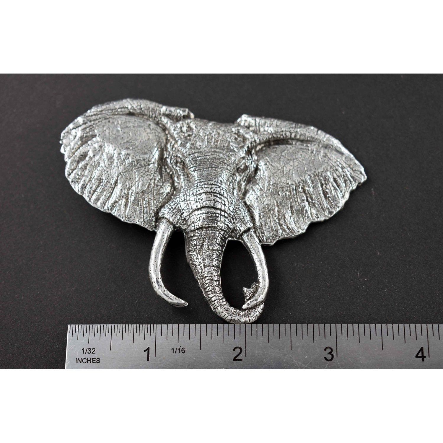 A handcrafted Elephant With Tusks Pin next to a ruler, available for sale at Creativeartisan.com - the image offers a sense of scale