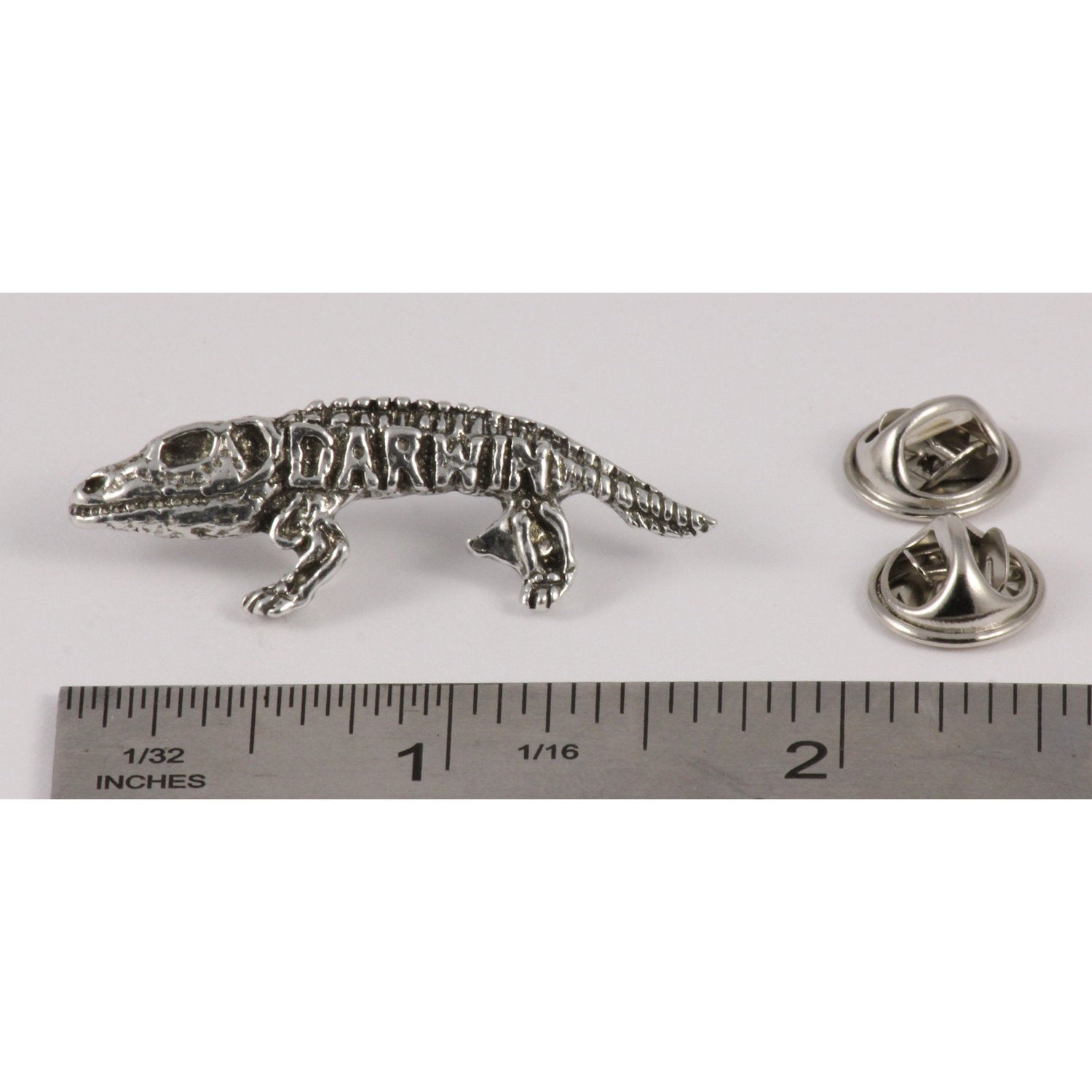 A handcrafted Darwin Pin next to a ruler, available for sale at Creativeartisan.com - the image offers a sense of scale