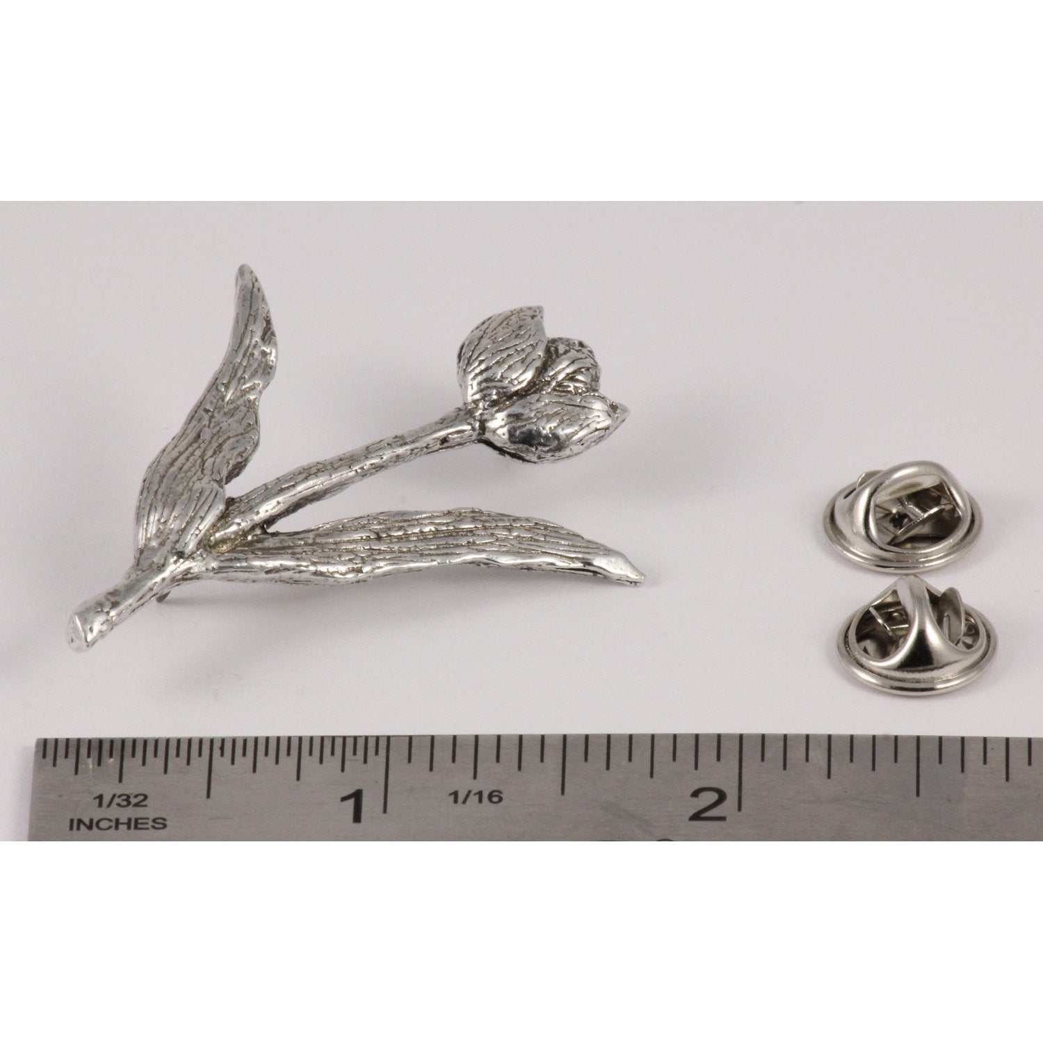 A handcrafted Tulip Pin next to a ruler, available for sale at Creativeartisan.com - the image offers a sense of scale