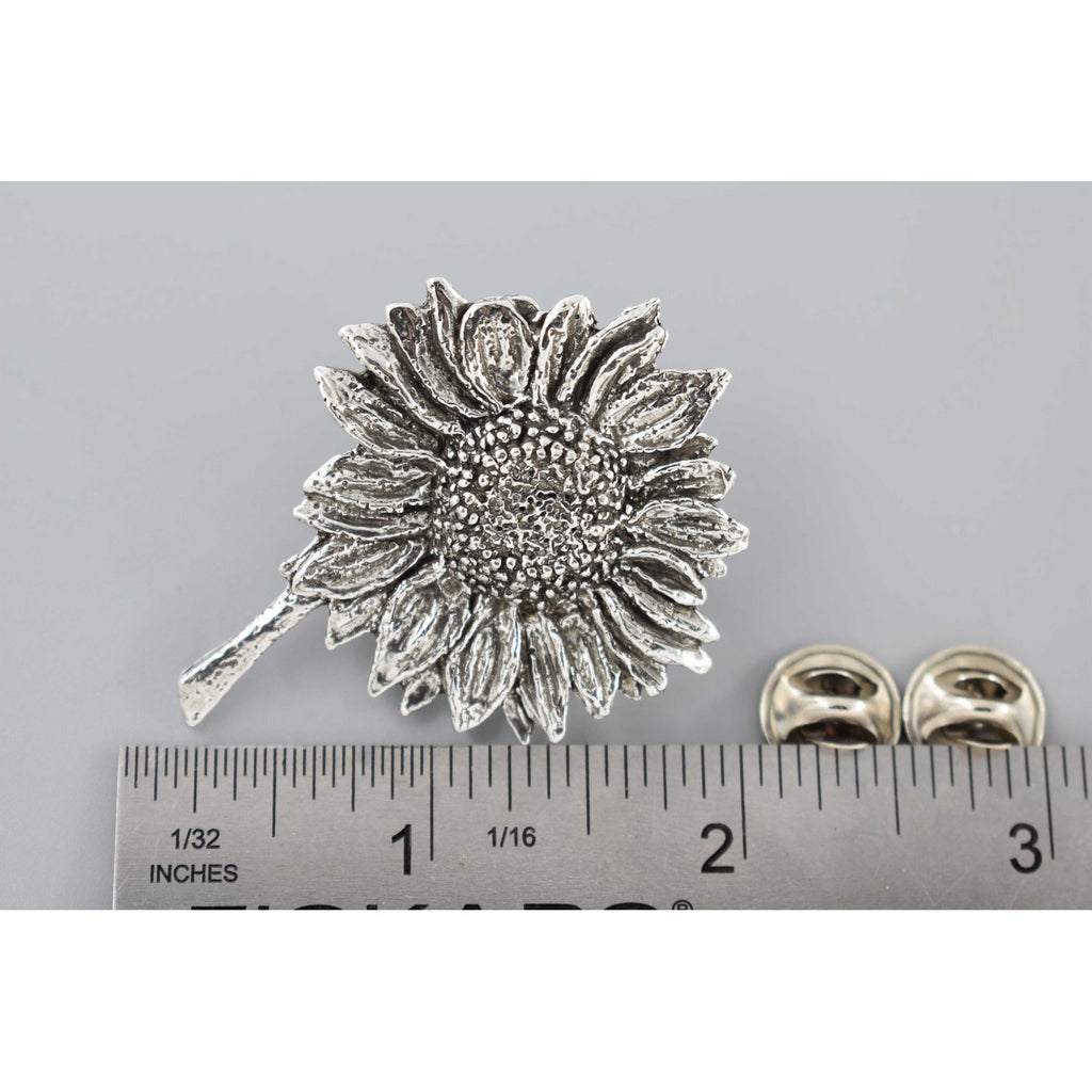 A handcrafted Sunflower Pin next to a ruler, available for sale at Creativeartisan.com - the image offers a sense of scale