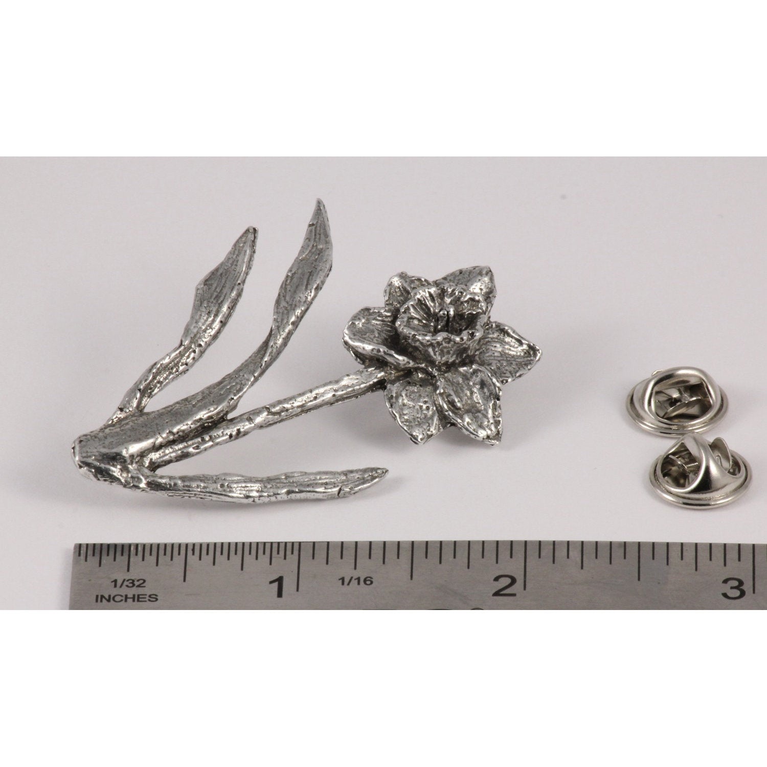 A handcrafted Daffodil Pin next to a ruler, available for sale at Creativeartisan.com - the image offers a sense of scale
