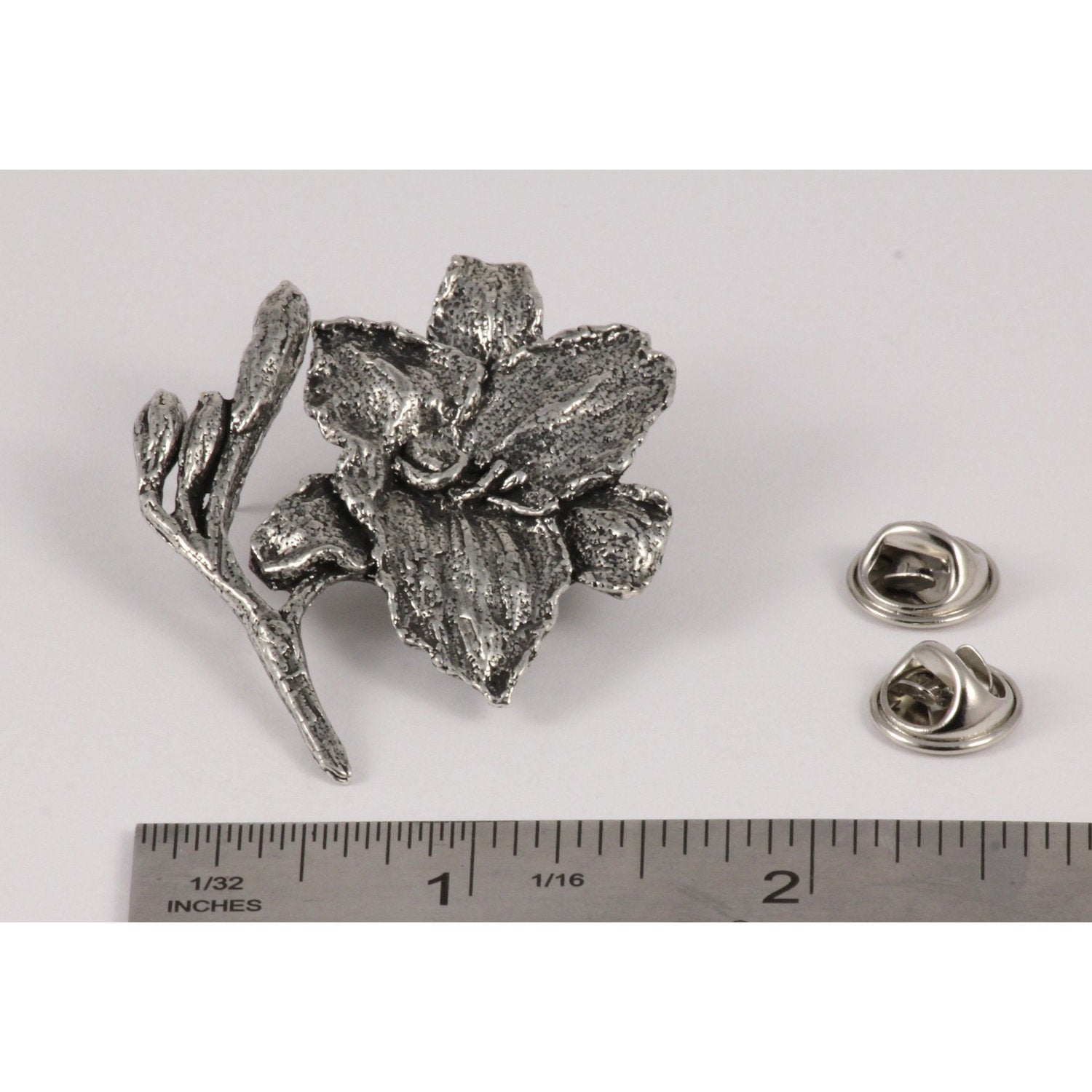 A handcrafted Day Lilly Pin next to a ruler, available for sale at Creativeartisan.com - the image offers a sense of scale