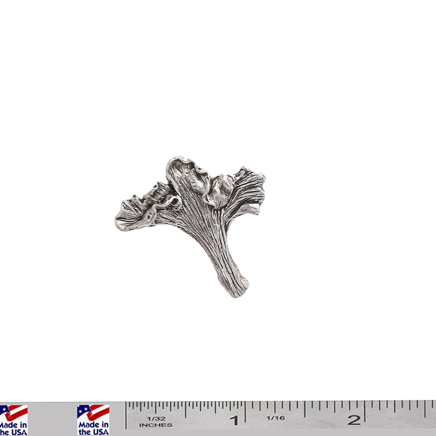 A handcrafted Chanterelle Mushroom Pin next to a ruler, available for sale at Creativeartisan.com - the image offers a sense of scale