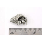 A handcrafted Hermit Crab Pin next to a ruler, available for sale at Creativeartisan.com - the image offers a sense of scale