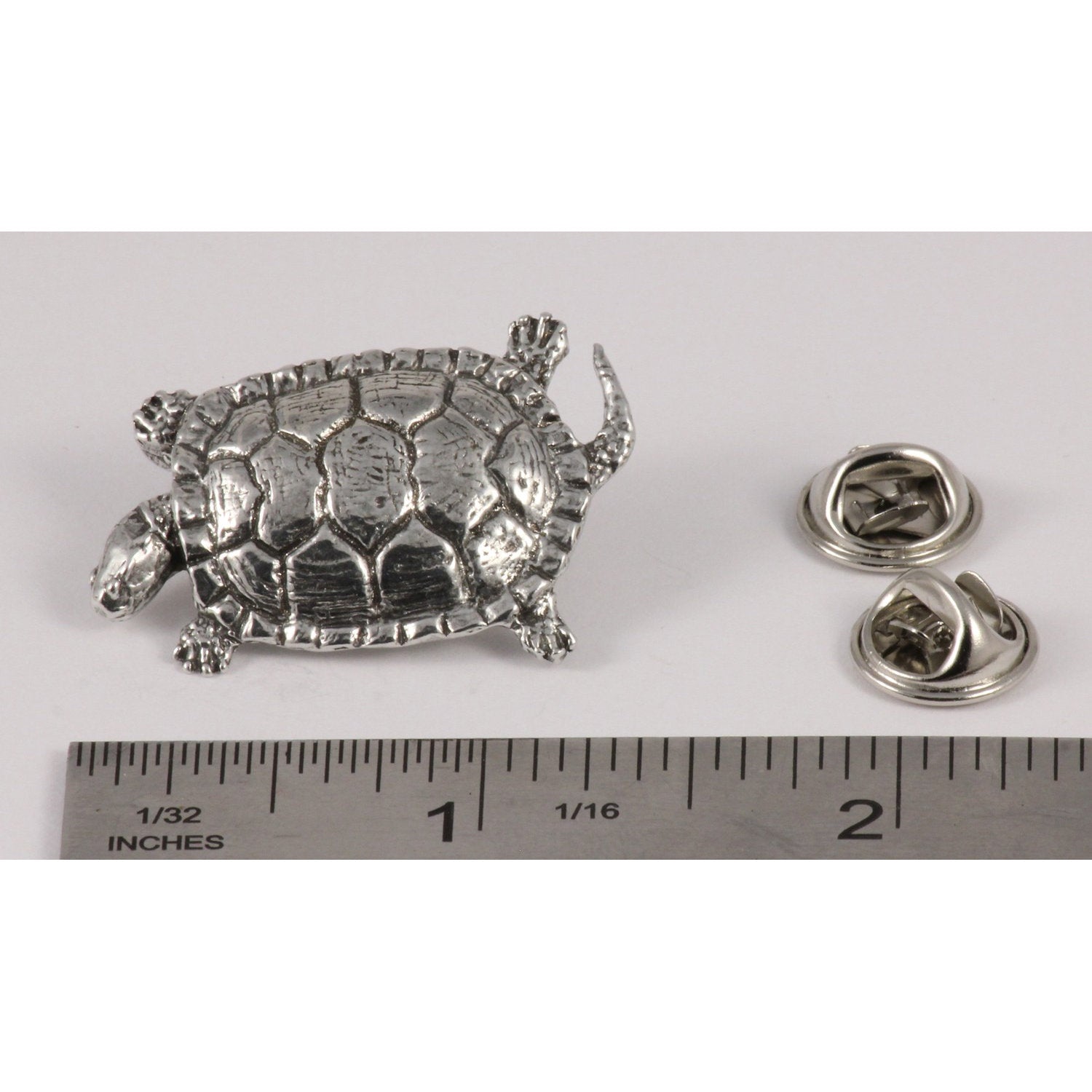 A handcrafted Pond Turtle Pin next to a ruler, available for sale at Creativeartisan.com - the image offers a sense of scale