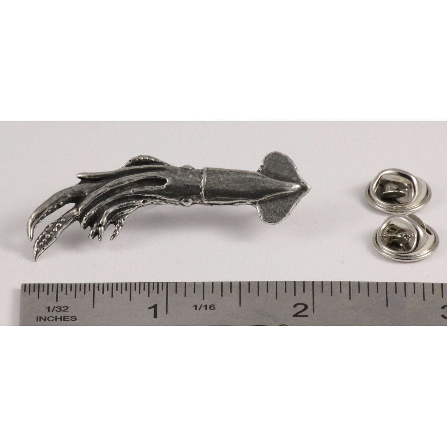 A handcrafted Squid Pin next to a ruler, available for sale at Creativeartisan.com - the image offers a sense of scale