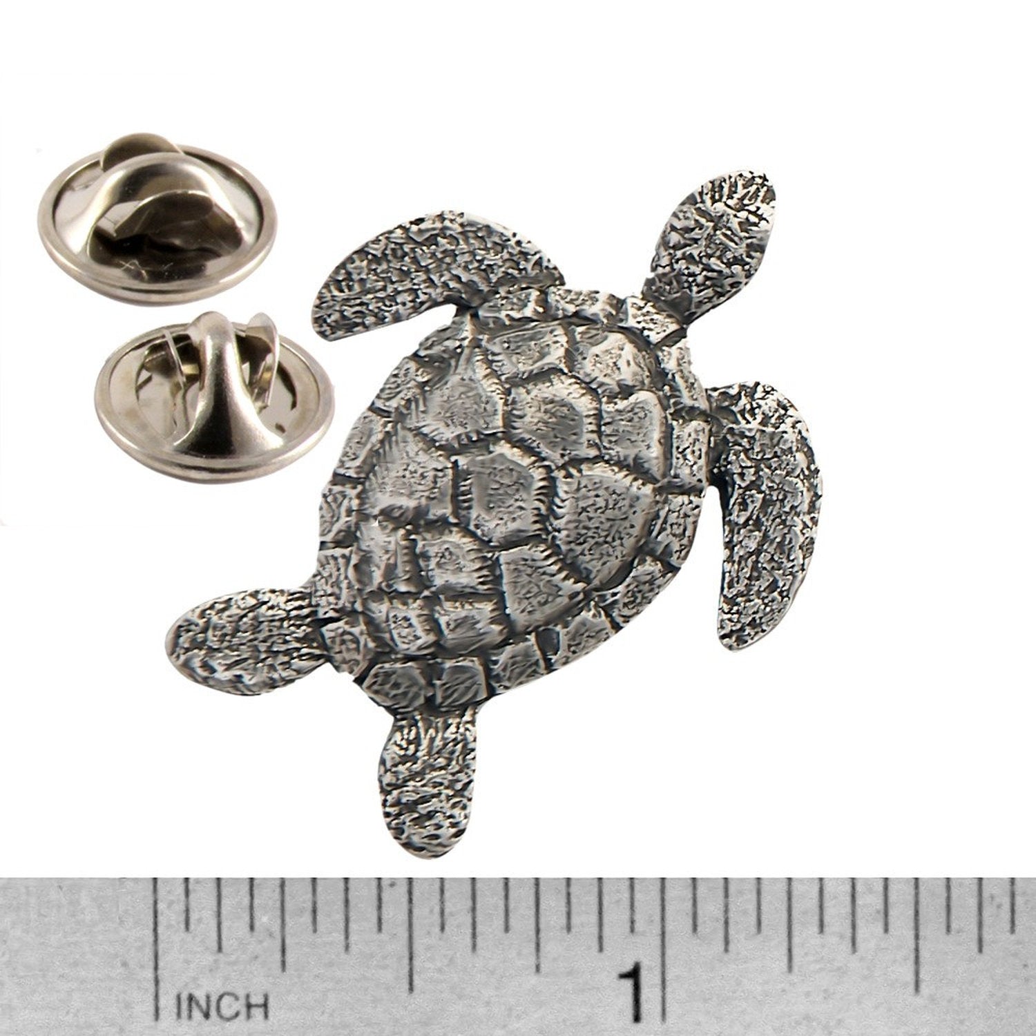 A handcrafted Sea Turtle Top View Pin next to a ruler, available for sale at Creativeartisan.com - the image offers a sense of scale