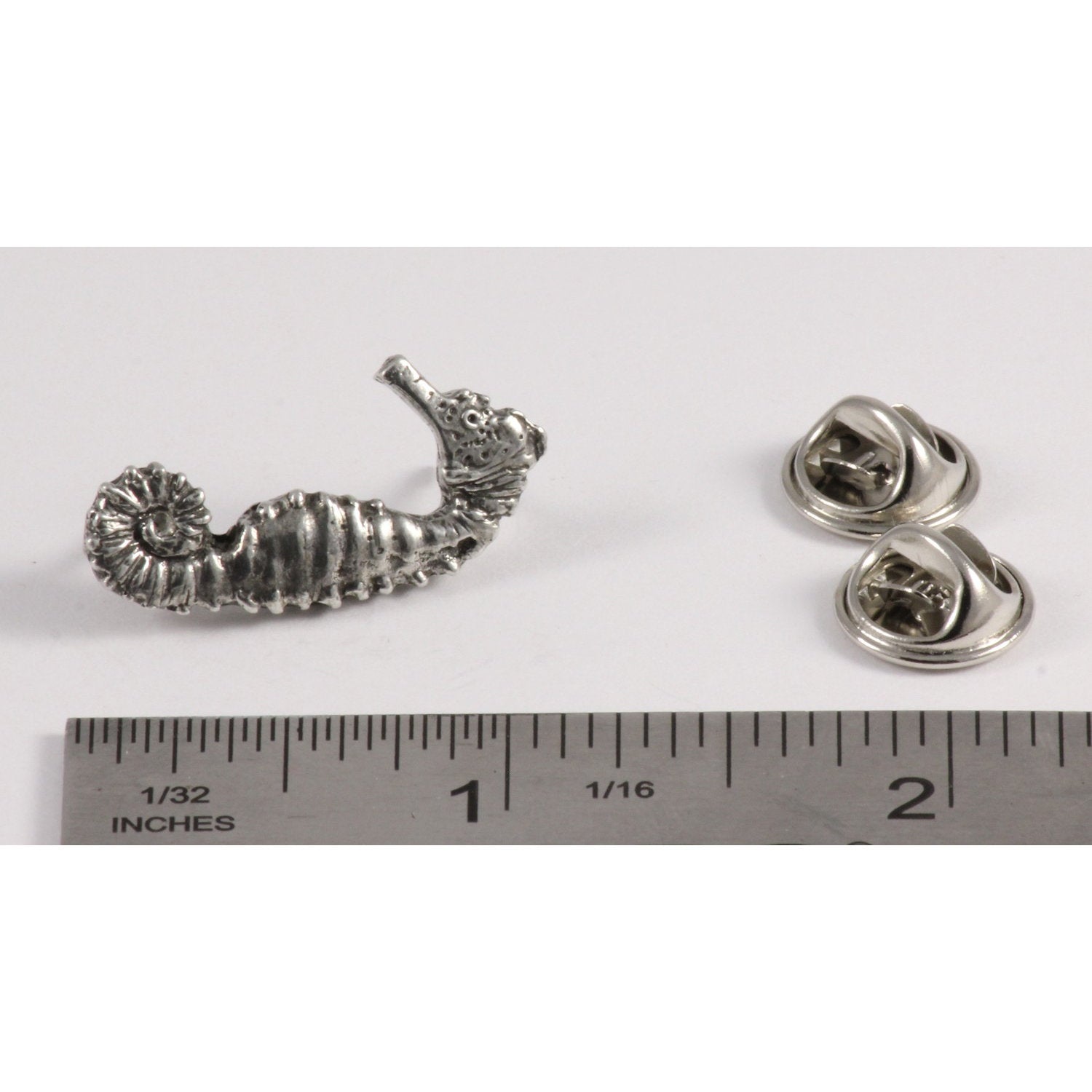 A handcrafted Seahorse Pin next to a ruler, available for sale at Creativeartisan.com - the image offers a sense of scale