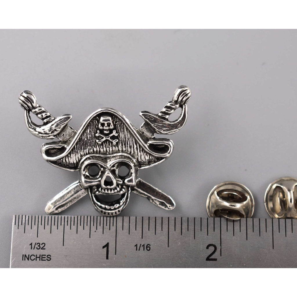 A handcrafted Pirate Head Pin next to a ruler, available for sale at Creativeartisan.com - the image offers a sense of scale