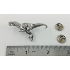 A handcrafted Tyrannosaurus Rex Pin next to a ruler, available for sale at Creativeartisan.com - the image offers a sense of scale