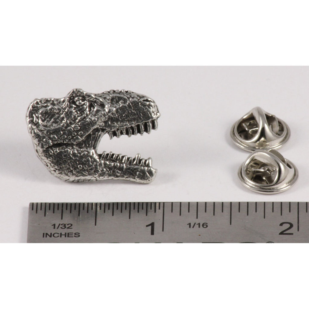A handcrafted Tyrannosaurus Rex Head Pin next to a ruler, available for sale at Creativeartisan.com - the image offers a sense of scale