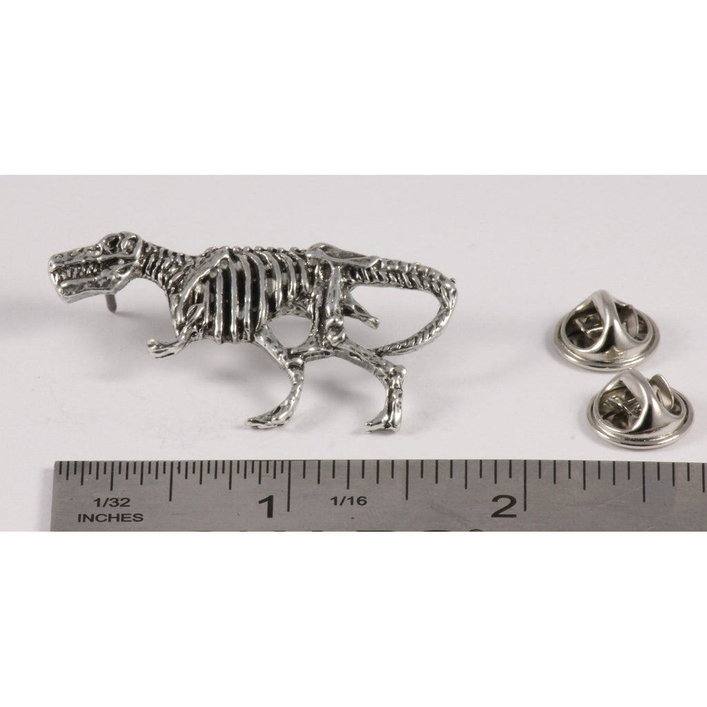 A handcrafted Tyrannosaurus Rex Fossilized Body Pin next to a ruler, available for sale at Creativeartisan.com - the image offers a sense of scale
