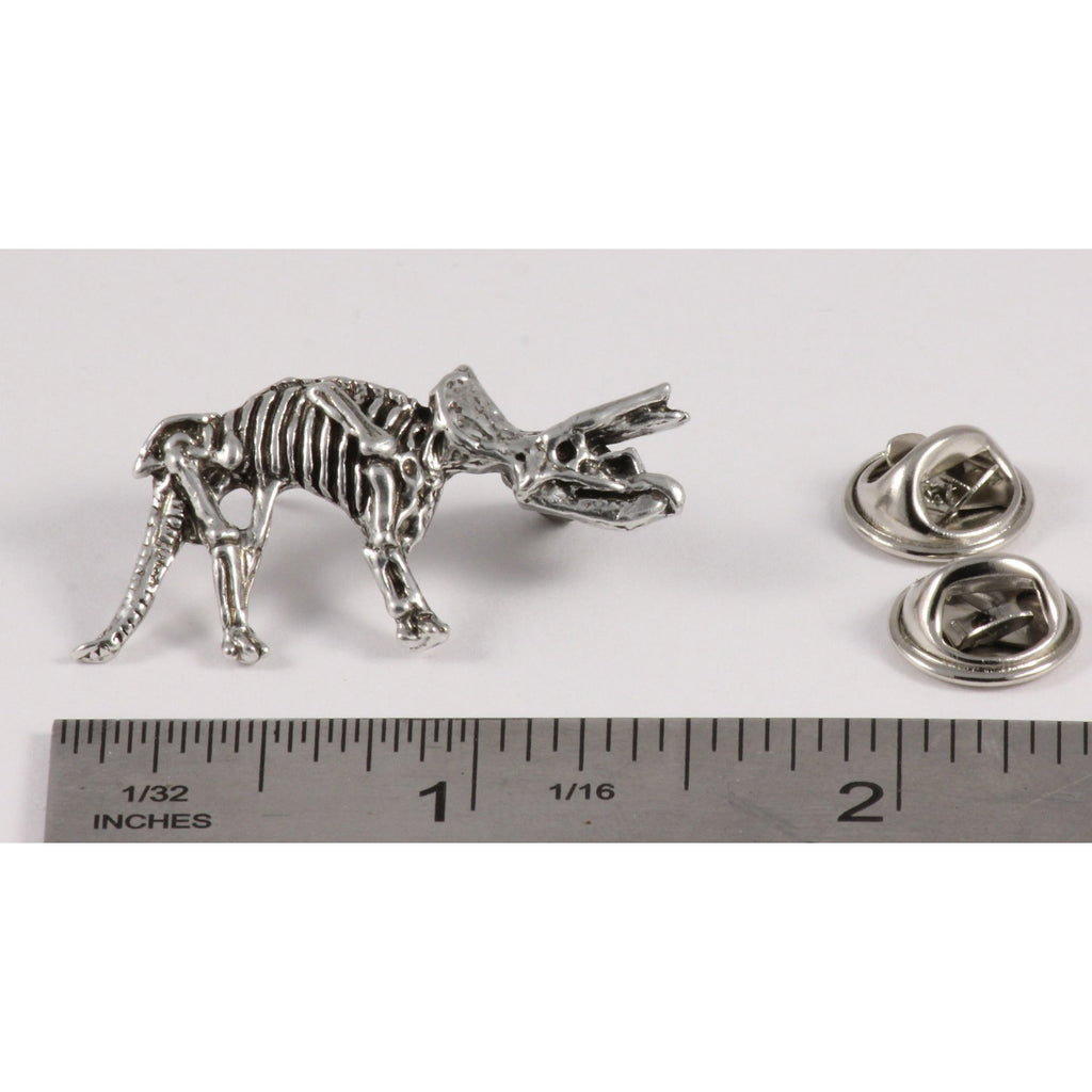 A handcrafted Triceratops Fossilized Full Body Pin next to a ruler, available for sale at Creativeartisan.com - the image offers a sense of scale