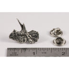 A handcrafted Triceratops Head Pin next to a ruler, available for sale at Creativeartisan.com - the image offers a sense of scale