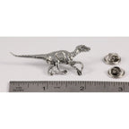 A handcrafted Velociraptor Pin next to a ruler, available for sale at Creativeartisan.com - the image offers a sense of scale