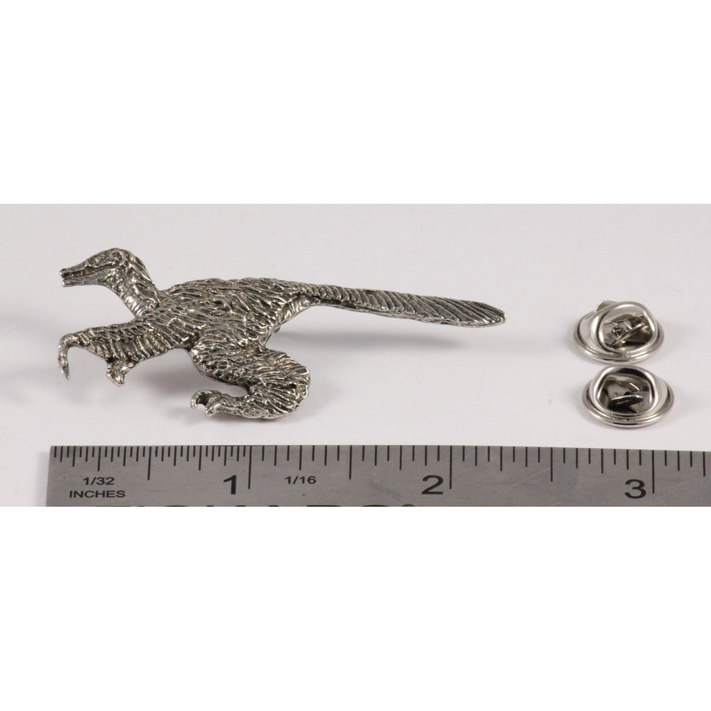 A handcrafted Feathered Velociraptor Pin next to a ruler, available for sale at Creativeartisan.com - the image offers a sense of scale