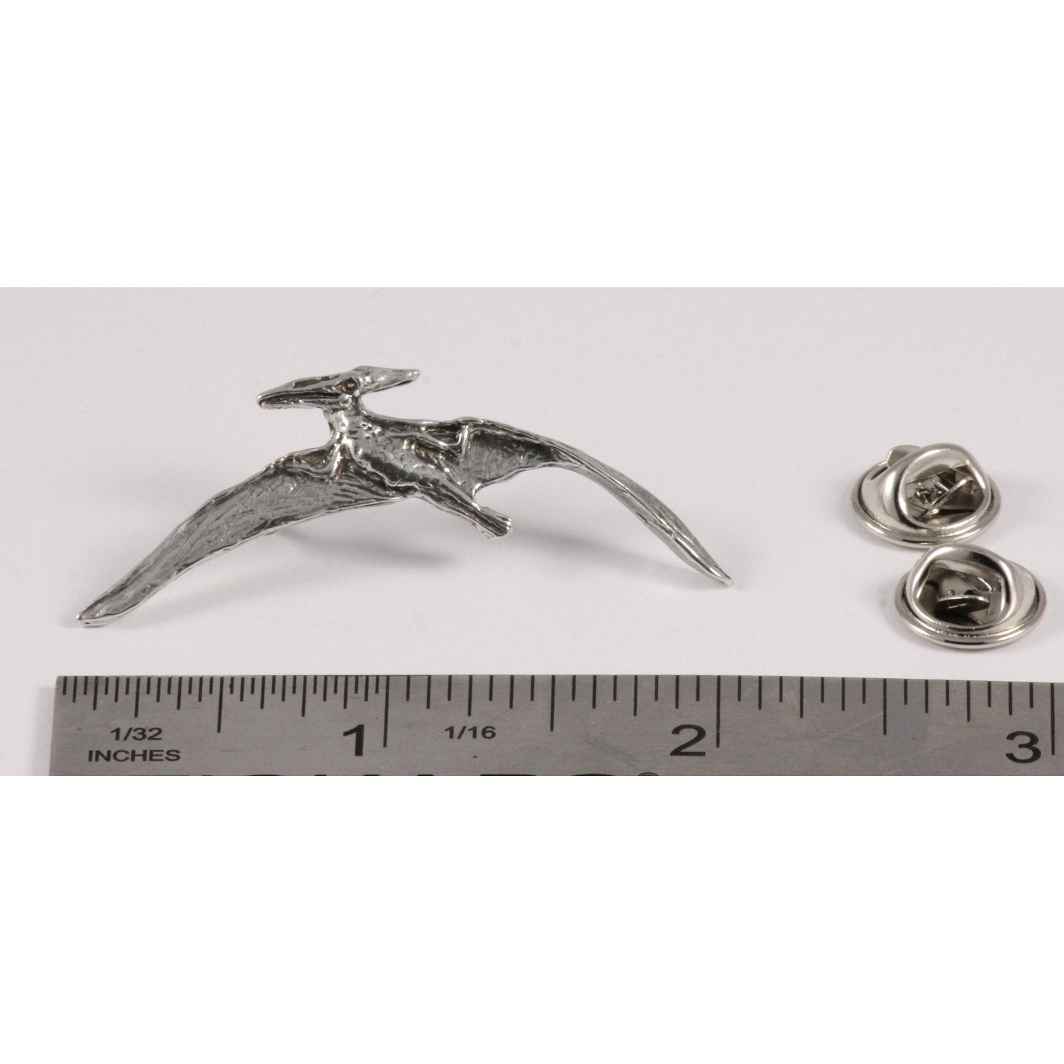A handcrafted Pterodactyl Flying Pin next to a ruler, available for sale at Creativeartisan.com - the image offers a sense of scale