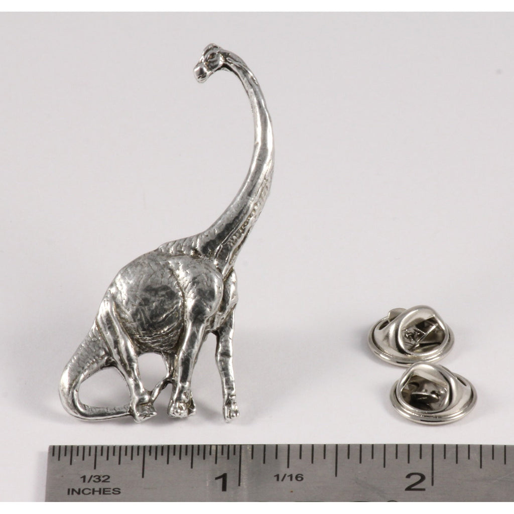 A handcrafted Brontosaurus Pin next to a ruler, available for sale at Creativeartisan.com - the image offers a sense of scale