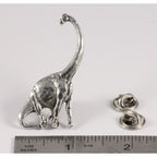 A handcrafted Brontosaurus Pin next to a ruler, available for sale at Creativeartisan.com - the image offers a sense of scale