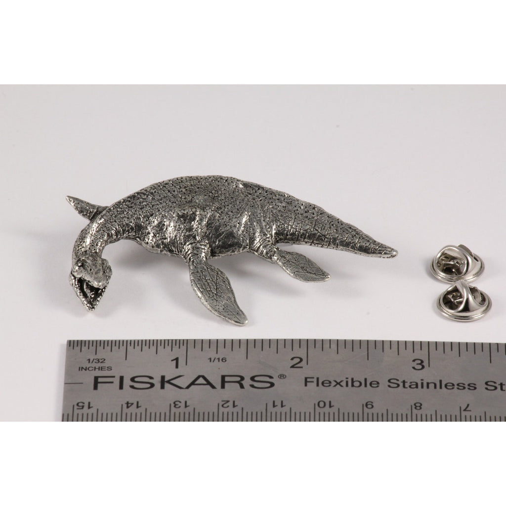 A handcrafted Elasmosaurus Prehistoric Marine Reptile Pin next to a ruler, available for sale at Creativeartisan.com - the image offers a sense of scale