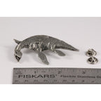 A handcrafted Elasmosaurus Prehistoric Marine Reptile Pin next to a ruler, available for sale at Creativeartisan.com - the image offers a sense of scale
