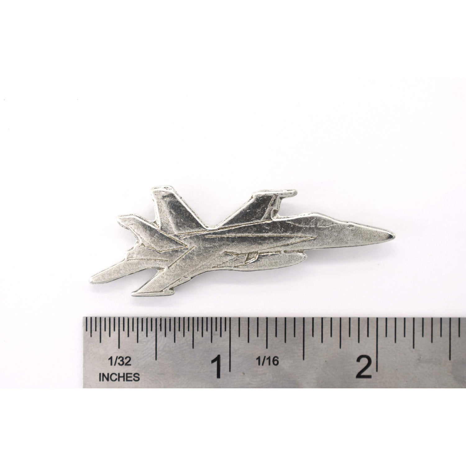 A handcrafted Fighter Jet Pin next to a ruler, available for sale at Creativeartisan.com - the image offers a sense of scale