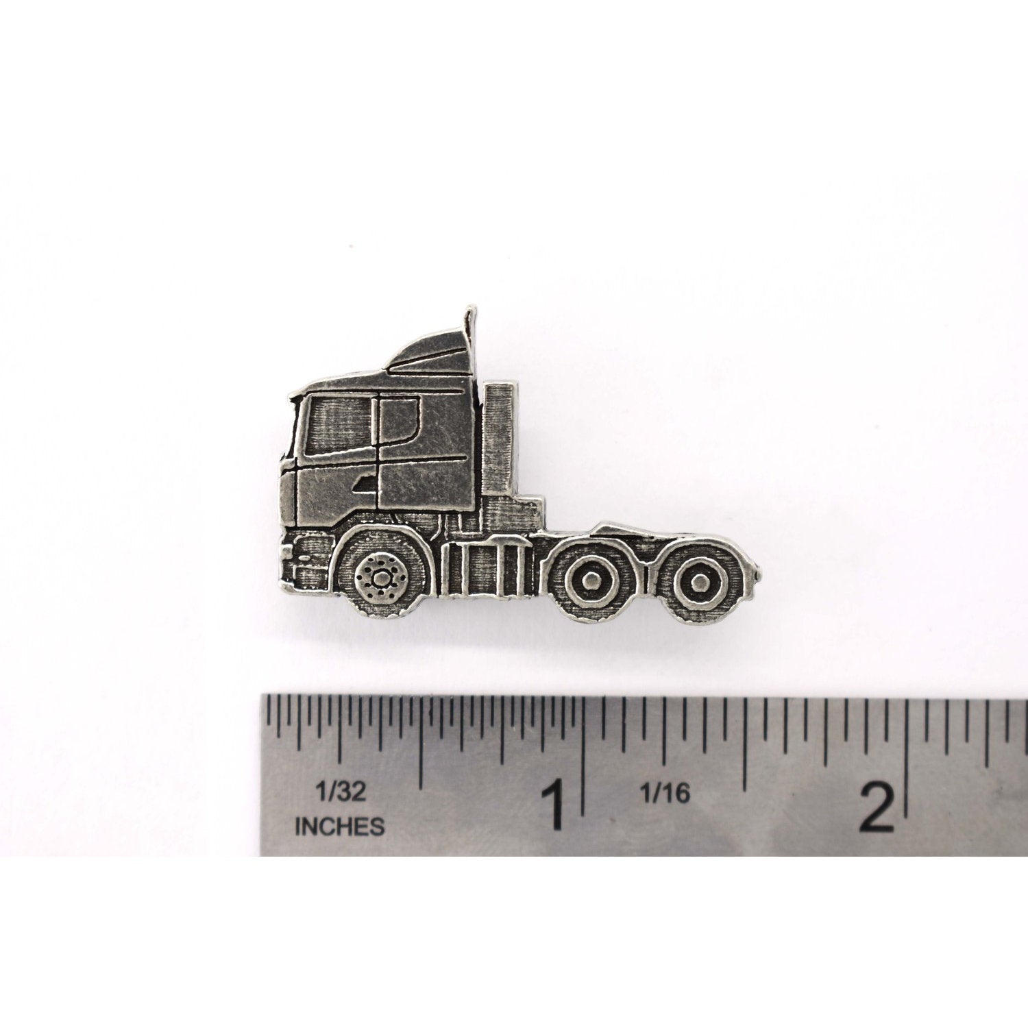 A handcrafted Semi Truck Short Nose Pin next to a ruler, available for sale at Creativeartisan.com - the image offers a sense of scale