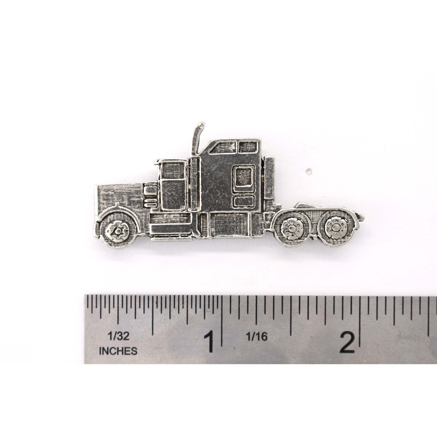 A handcrafted Semi Truck Pin next to a ruler, available for sale at Creativeartisan.com - the image offers a sense of scale
