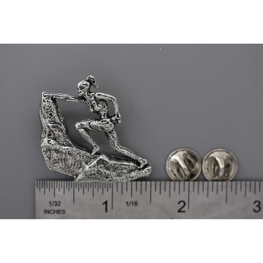 A handcrafted Rock Climber Female Pin next to a ruler, available for sale at Creativeartisan.com - the image offers a sense of scale