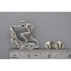 A handcrafted Rock Climber Male Pin next to a ruler, available for sale at Creativeartisan.com - the image offers a sense of scale