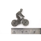 A handcrafted Bicycler Pin next to a ruler, available for sale at Creativeartisan.com - the image offers a sense of scale