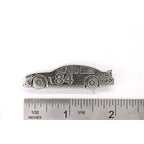 A handcrafted Race Car Pin next to a ruler, available for sale at Creativeartisan.com - the image offers a sense of scale