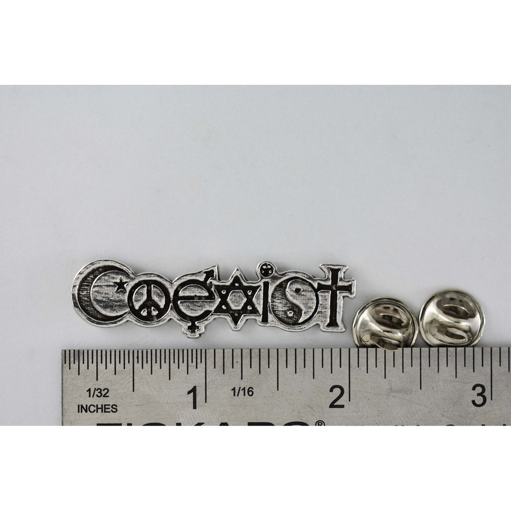 A handcrafted Coexist Pin next to a ruler, available for sale at Creativeartisan.com - the image offers a sense of scale